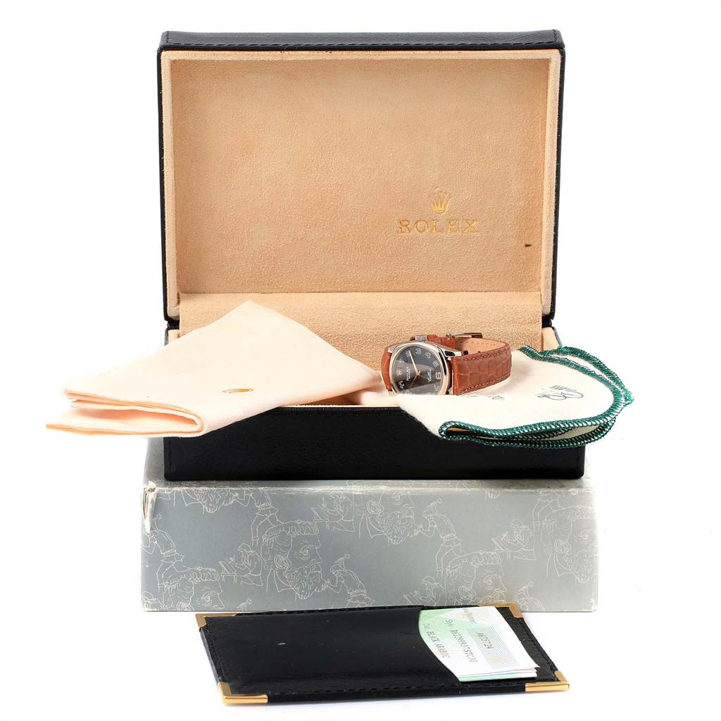 The image shows a Rolex Cellini 6229 Women's White Gold Black Dial 6229 Women's White Gold Black Dial watch at a slight right angle, along with its open box, cloth, paperwork, and accessories.