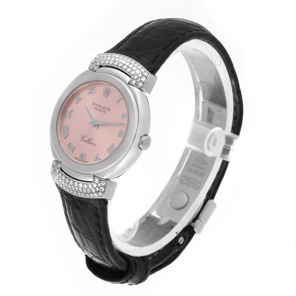 This image shows a Rolex Cellini 6672 Women's White Gold Pink Dial 6672 Women's White Gold Pink Dial watch at an oblique angle, highlighting its pink dial, silver case, and black leather strap.