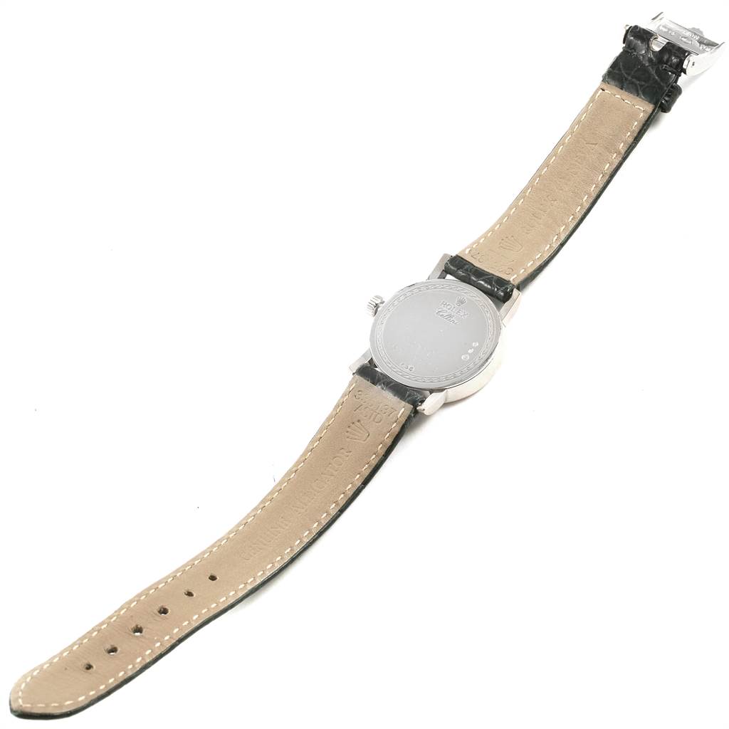 The image shows the back view of a Rolex Cellini 6110 Women
s White Gold Silver Dial 6110 Women
s White Gold Silver Dial watch, highlighting its caseback, strap, and buckle.