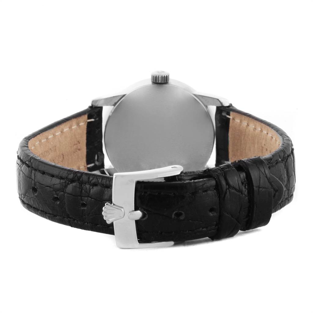 The image shows the back view of the Rolex Cellini 6111 Women
s White Gold Silver Dial 6111 Women
s White Gold Silver Dial watch, highlighting its buckle and black leather strap.