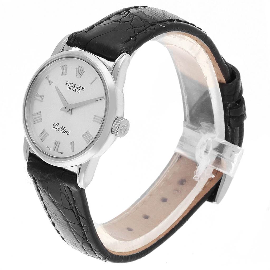 The image shows a Rolex Cellini 6111 Women
s White Gold Silver Dial 6111 Women
s White Gold Silver Dial watch at an angled side view, featuring its dial, casing, and black leather strap.
