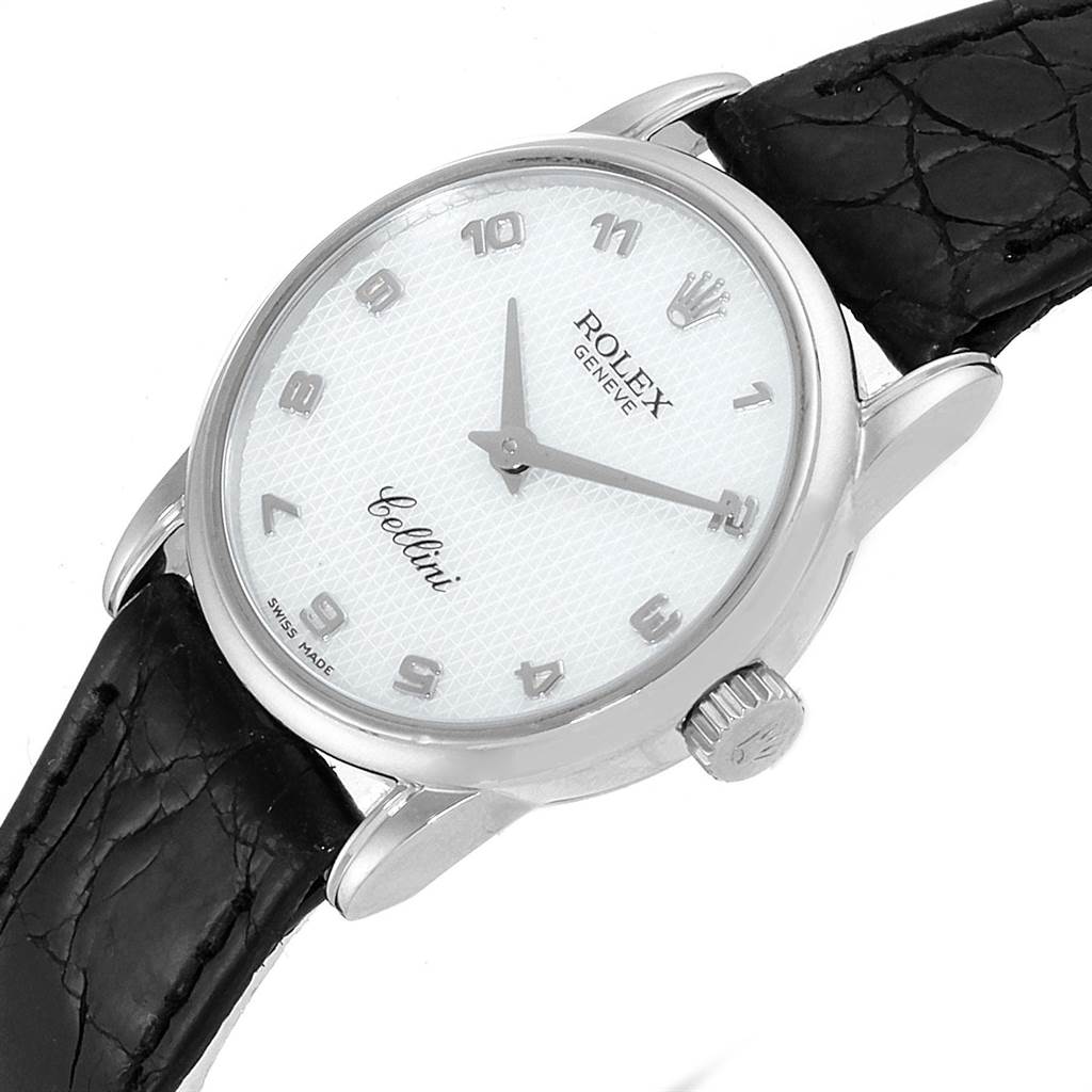 The Rolex Cellini 6111 Women's White Gold Mother of Pearl Dial 6111 Women's White Gold Mother of Pearl Dial watch is shown at a slight angle, highlighting its white dial, silver hands, black leather strap, and crown.