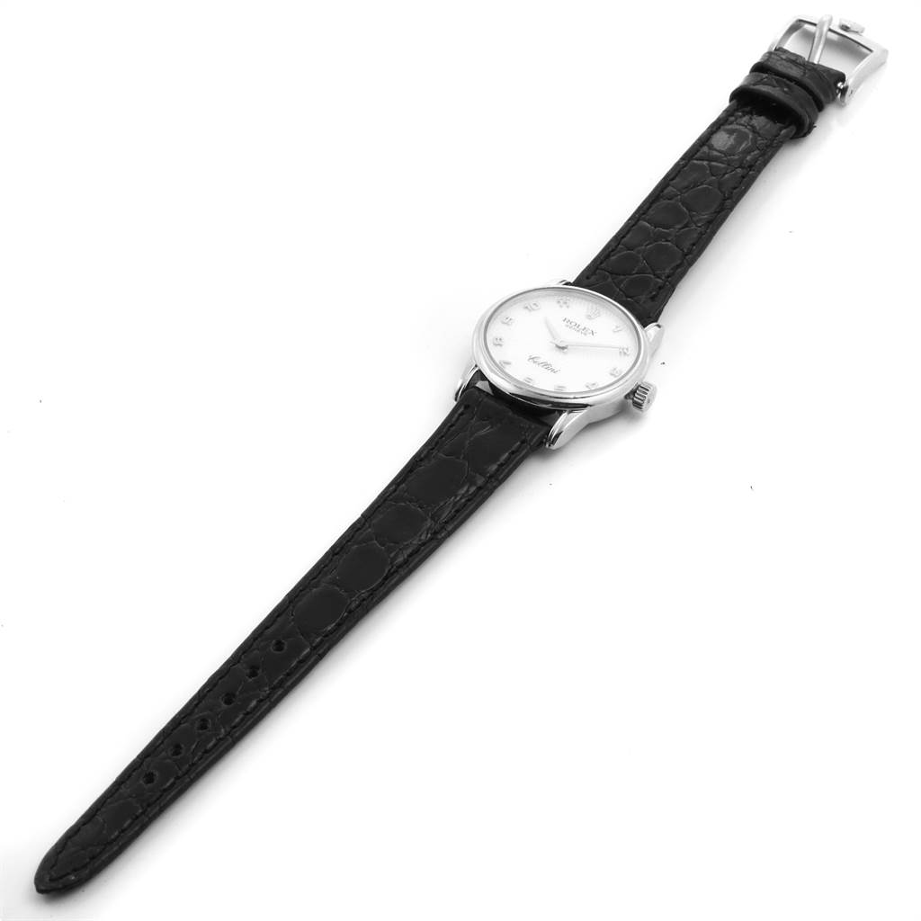 The Rolex Cellini 6111 Women's White Gold Mother of Pearl Dial 6111 Women's White Gold Mother of Pearl Dial watch is shown in a top view, displaying the dial, case, crown, and leather strap with a buckle.