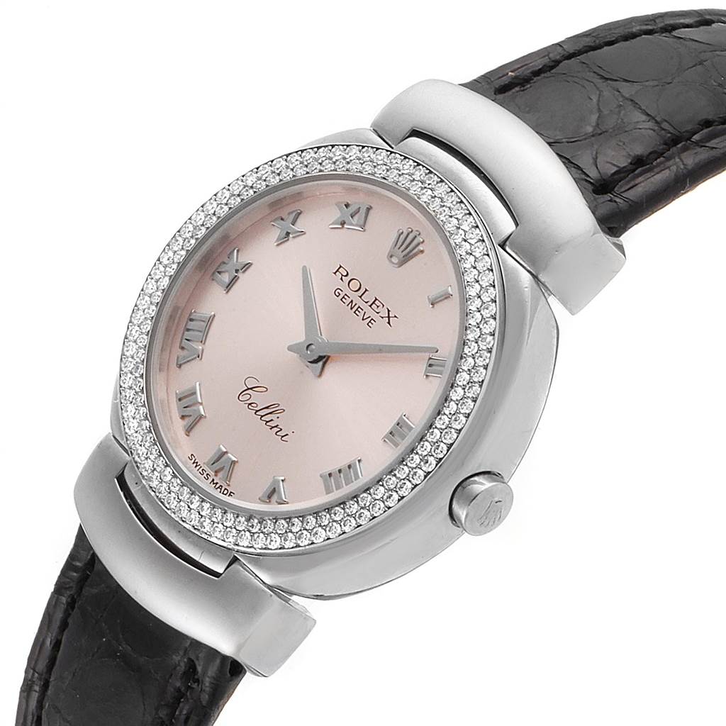 This image shows a tilted view of a Rolex Cellini 6671 Women's White Gold Pink Dial 6671 Women's White Gold Pink Dial watch, featuring its face, bezel, case, and leather strap.