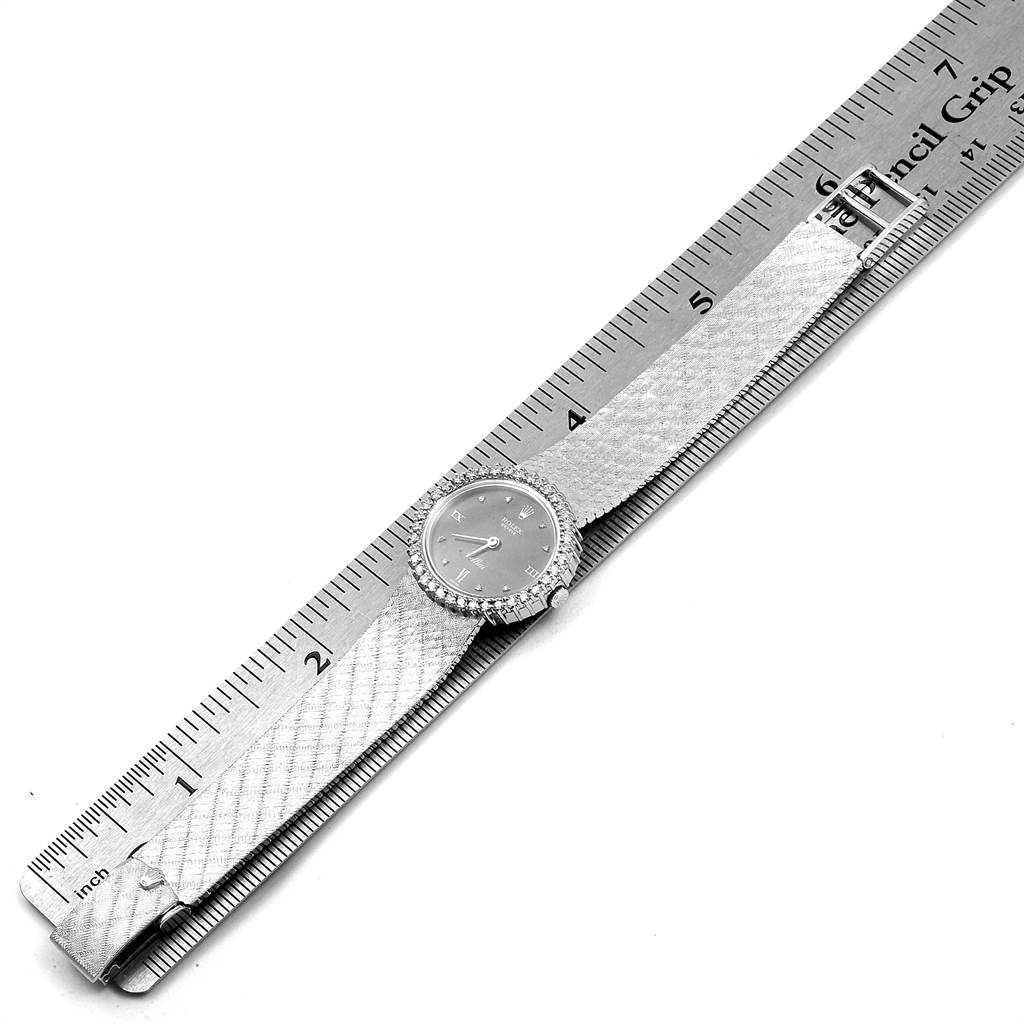 The Rolex Cellini 6673 Women
s White Gold Grey Dial 6673 Women
s White Gold Grey Dial watch is shown horizontally, centering on the dial and strap with a ruler for scale.