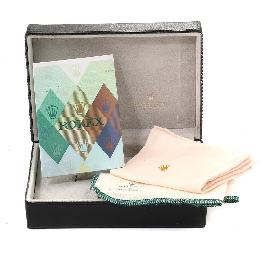 The image shows a Rolex Cellini 6110 Women's Yellow Gold Mother of Pearl Dial 6110 Women's Yellow Gold Mother of Pearl Dial watch box with a booklet and cleaning cloths inside the box.