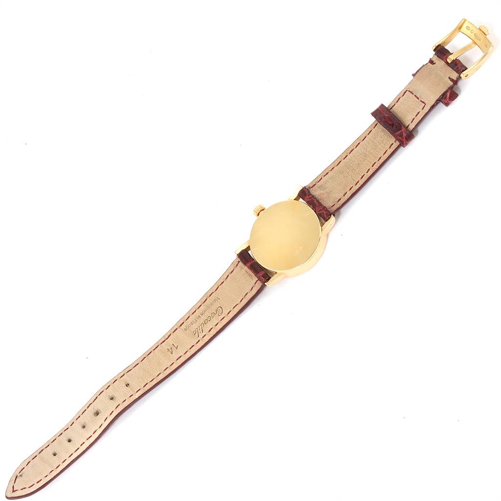 The image shows the back view of a Rolex Cellini 6110 Women's Yellow Gold Mother of Pearl Dial 6110 Women's Yellow Gold Mother of Pearl Dial watch with a brown leather strap and buckle.