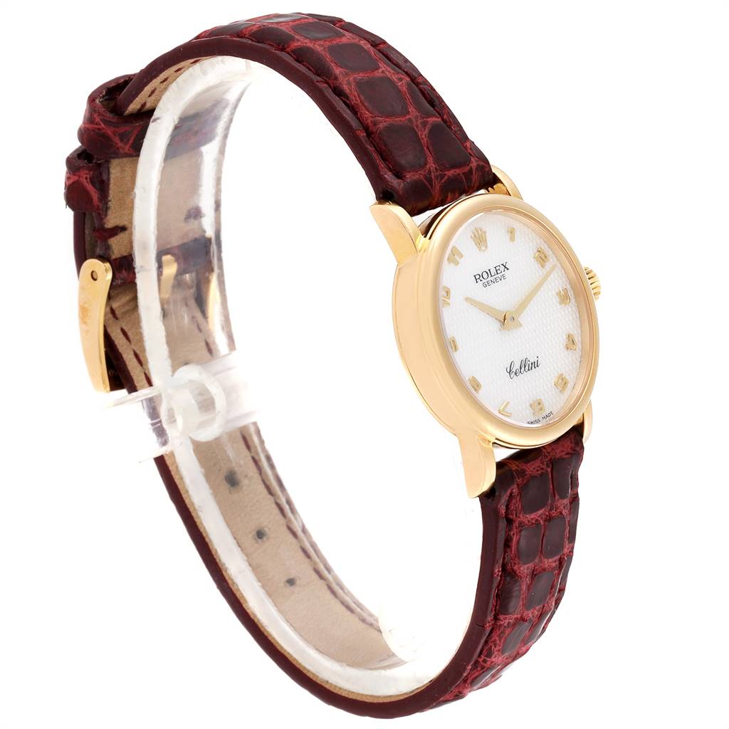 The Rolex Cellini 6110 Women's Yellow Gold Mother of Pearl Dial 6110 Women's Yellow Gold Mother of Pearl Dial watch is shown at a side angle, highlighting the gold case, white dial, and brown leather strap.