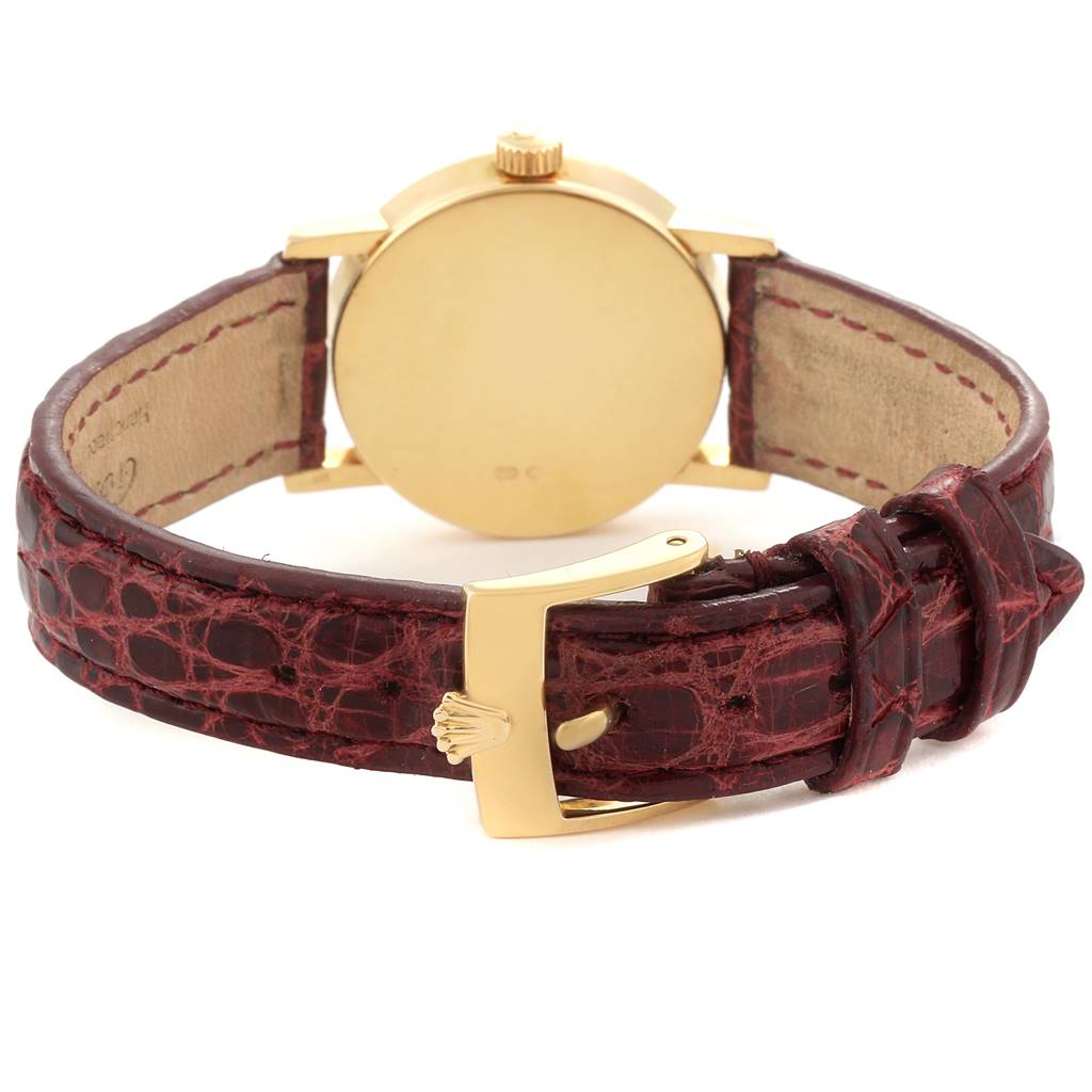 This image shows the back view of a Rolex Cellini 6110 Women's Yellow Gold Mother of Pearl Dial 6110 Women's Yellow Gold Mother of Pearl Dial watch, highlighting its gold case, crown, and leather strap with a gold buckle.