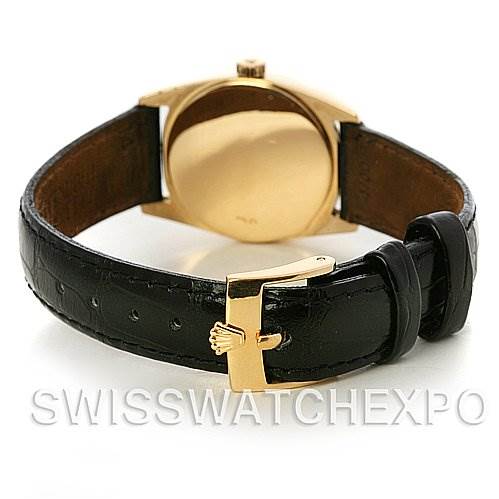 The image shows the Rolex Cellini 6229 Women's Yellow Gold White Dial 6229 Women's Yellow Gold White Dial watch from the back, highlighting its gold case and black leather strap with a gold buckle.