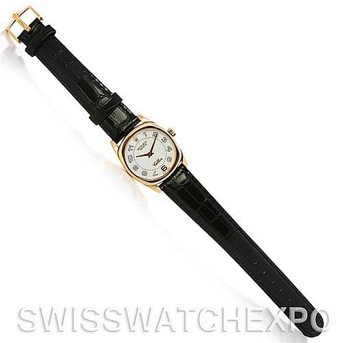 The image shows a top-down view of a Rolex Cellini 6229 Women's Yellow Gold White Dial 6229 Women's Yellow Gold White Dial watch featuring its entire black leather strap and gold case.