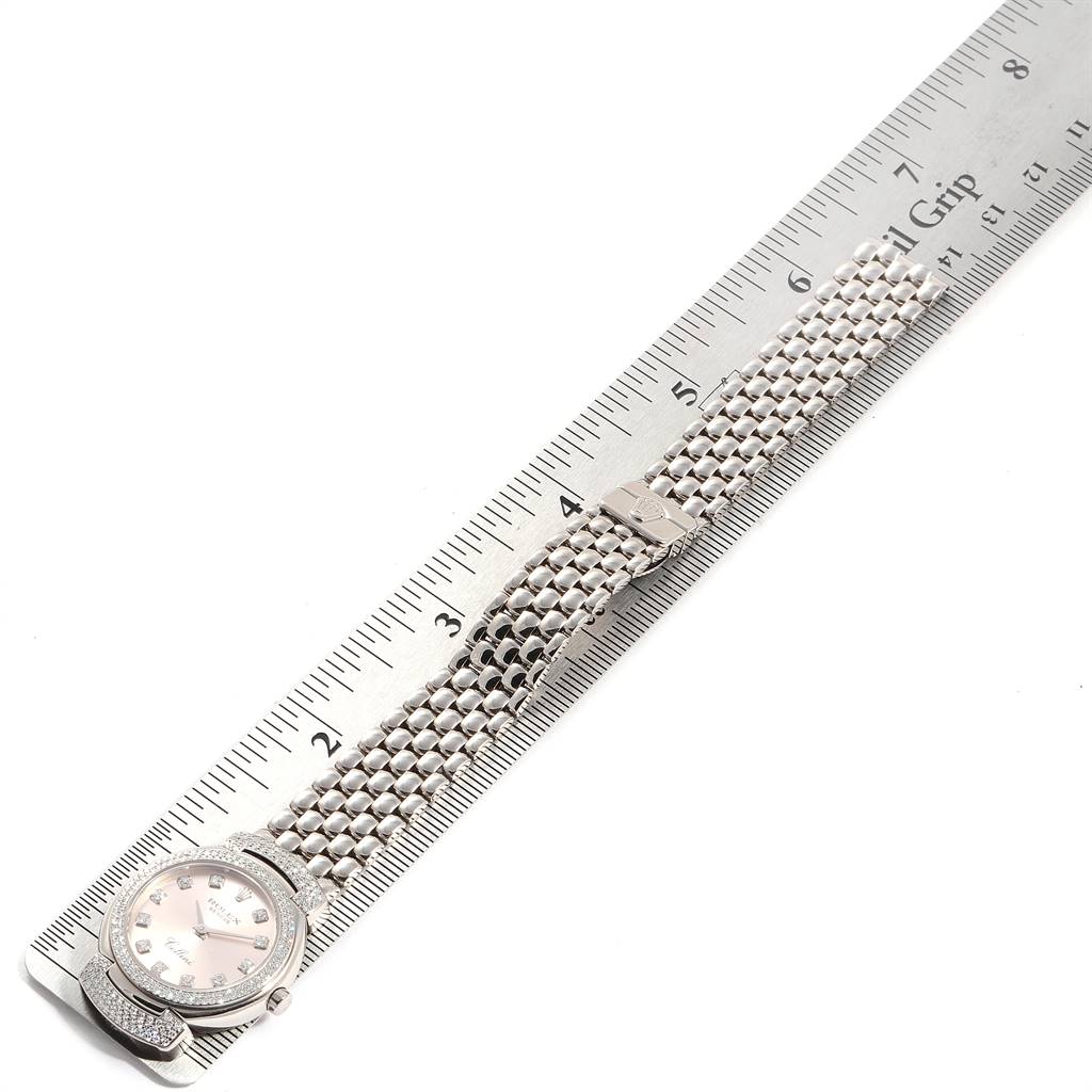 The Rolex Cellini 6673 Women's White Gold Pink Dial 6673 Women's White Gold Pink Dial watch is shown laid flat next to a ruler, displaying its face and band from a top-down angle.