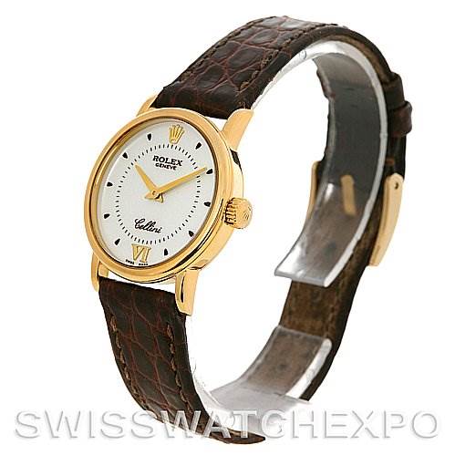 The image shows a side and front angle of a Rolex Cellini 6110 Women's Yellow Gold Silver Dial 6110 Women's Yellow Gold Silver Dial watch, displaying the watch face and leather strap.
