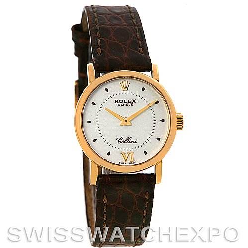 The Rolex Cellini 6110 Women's Yellow Gold Silver Dial 6110 Women's Yellow Gold Silver Dial watch is shown from a front angle, highlighting its face, gold bezel, and brown leather strap.