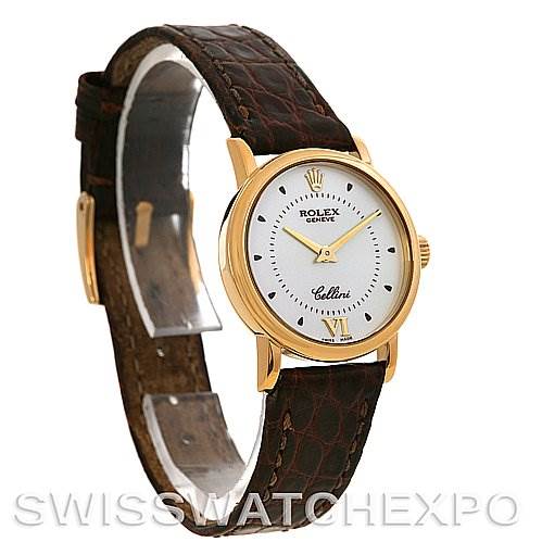 The Rolex Cellini 6110 Women's Yellow Gold Silver Dial 6110 Women's Yellow Gold Silver Dial watch is shown at a slight side angle, displaying its gold case, white dial, and brown leather strap.