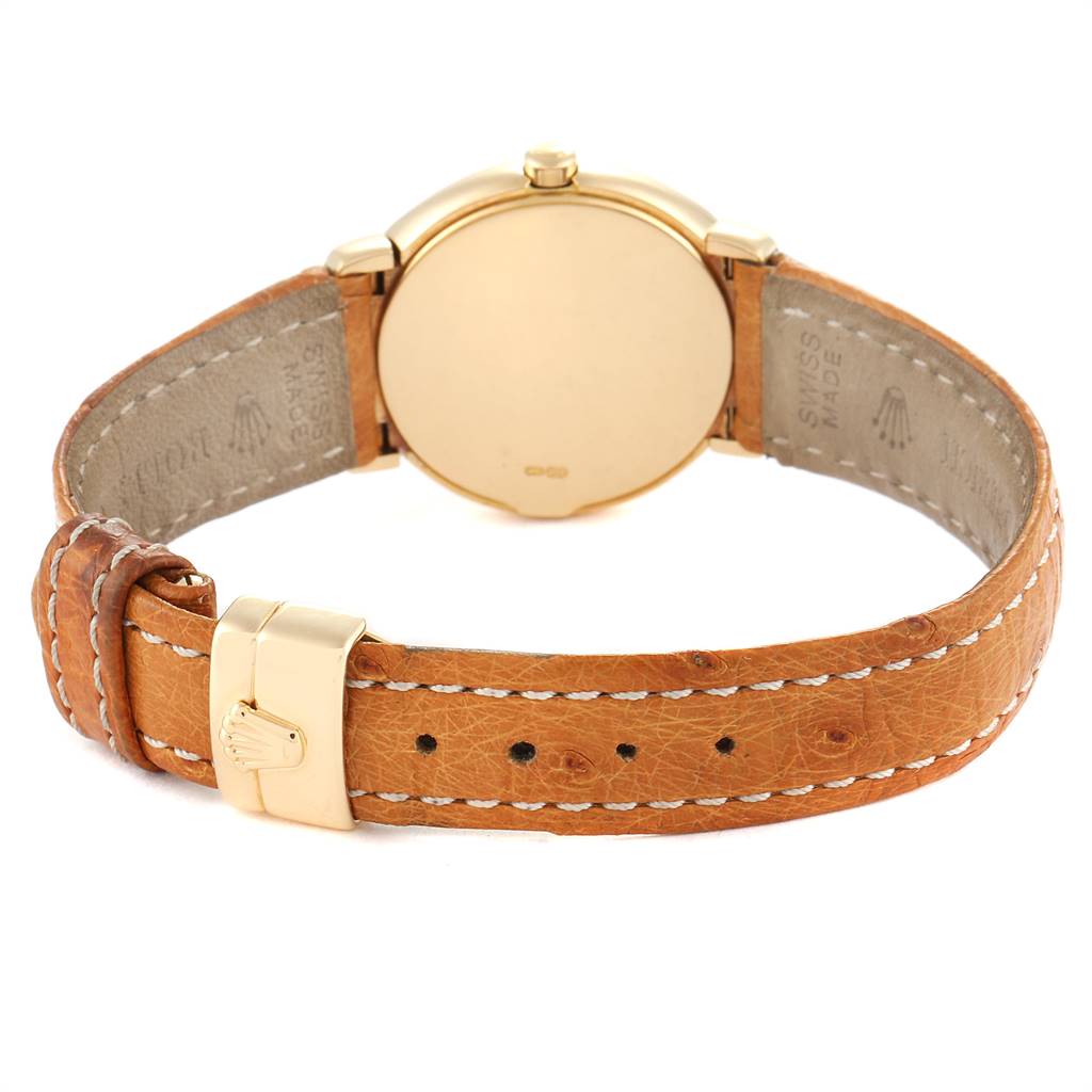 This image shows the back view of a Rolex Cellini 6621 Women's Yellow Gold White Dial 6621 Women's Yellow Gold White Dial watch, featuring its golden case and brown leather strap with a buckle.