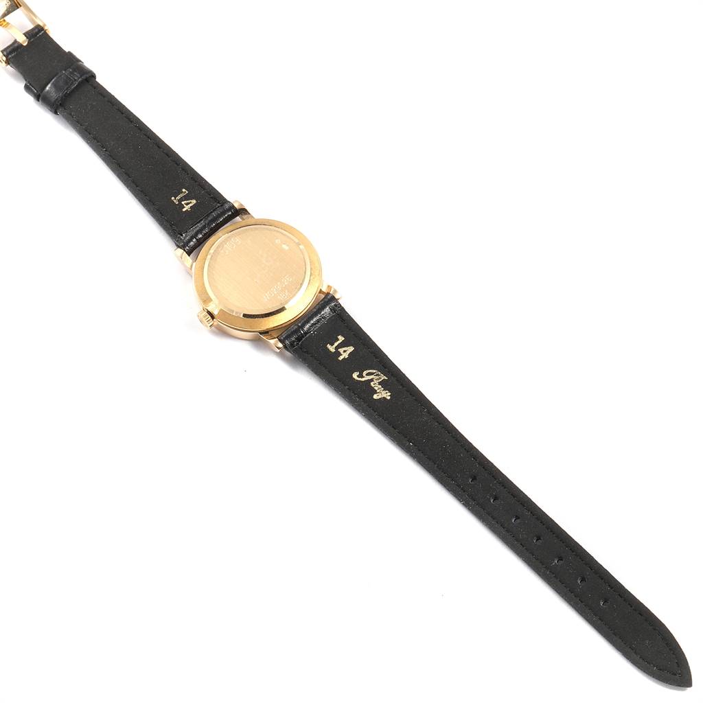 The image shows the back and leather straps of a Rolex Cellini 5109 Women's Yellow Gold Champagne Dial 5109 Women's Yellow Gold Champagne Dial model watch laid flat.