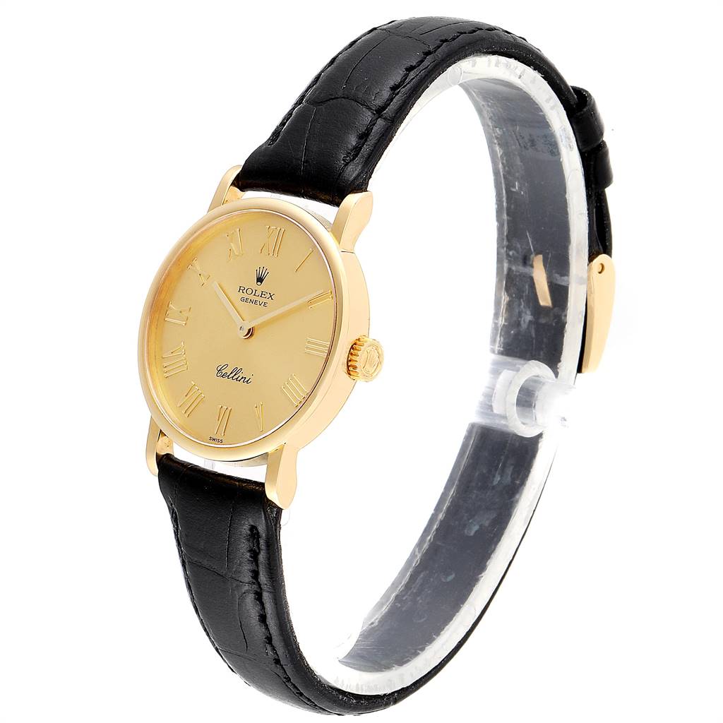 The image shows a side and front angle of a Rolex Cellini 5109 Women's Yellow Gold Champagne Dial 5109 Women's Yellow Gold Champagne Dial watch, highlighting its gold case and black leather strap.