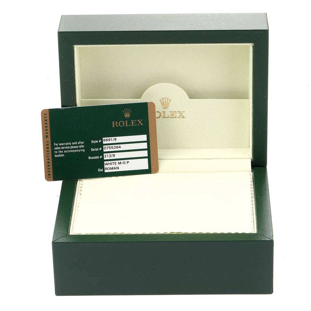 This image shows the open box and warranty card for a Rolex Cellini 6691 Women's White Gold Champagne Dial 6691 Women's White Gold Champagne Dial model watch.