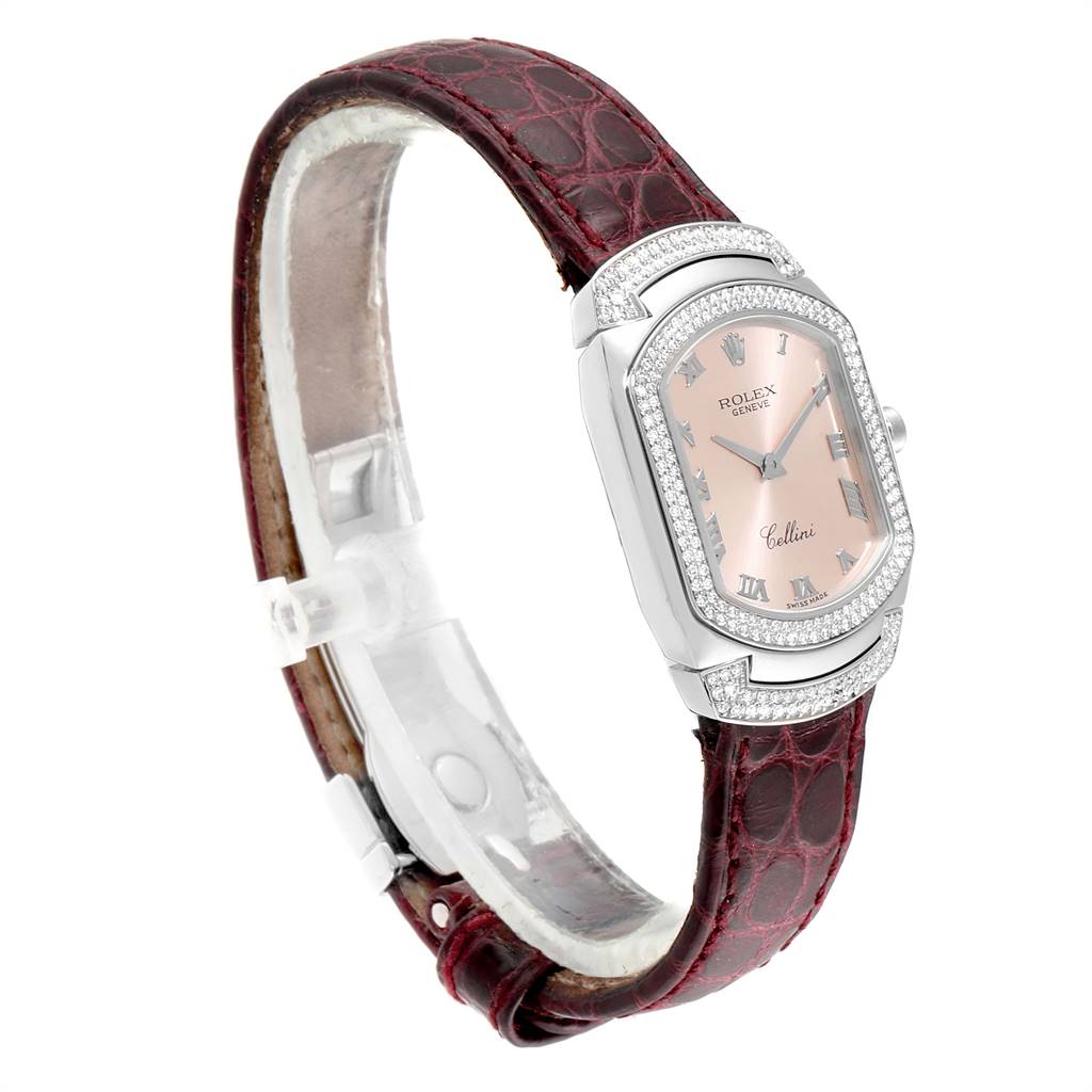 The Rolex Cellini 6693 Women's White Gold Pink Dial 6693 Women's White Gold Pink Dial watch is shown in a three-quarter angle, showcasing its face, bezel, and maroon leather strap.