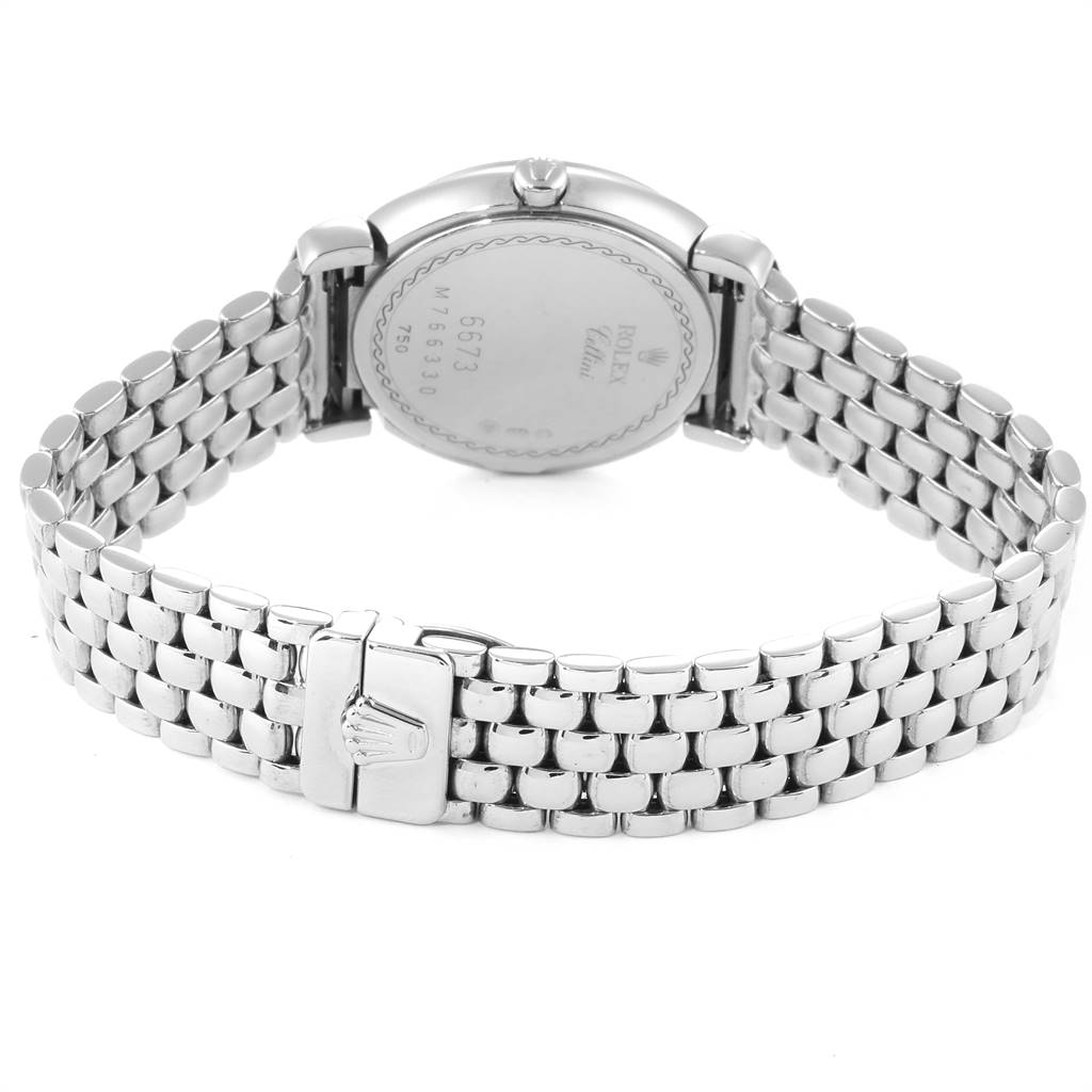 The image shows the back view of a Rolex Cellini 6673 Women
s White Gold Silver Dial 6673 Women
s White Gold Silver Dial watch, highlighting the case back and metal bracelet with the clasp.