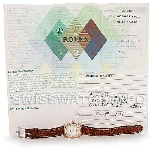 The image shows the Rolex Cellini 6229 Women's White Gold White Dial 6229 Women's White Gold White Dial watch with a brown leather strap laid out in front of its warranty paperwork.