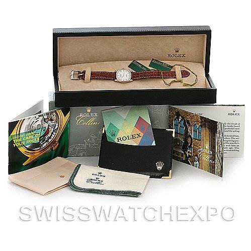 The Rolex Cellini 6229 Women's White Gold White Dial 6229 Women's White Gold White Dial watch is shown inside its original box, accompanied by brochures, booklets, and cleaning cloths.