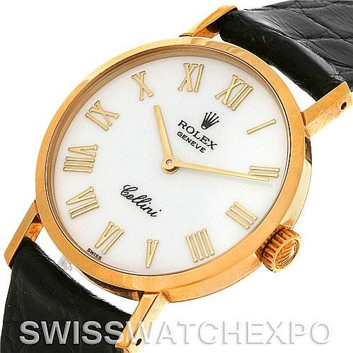 The image shows a Rolex Cellini 4109 Women
s Yellow Gold White Dial 4109 Women
s Yellow Gold White Dial watch from an angled top view, highlighting the face, Roman numeral markers, gold case, and a part of the leather strap.