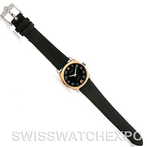 The image shows a top view of the Rolex Cellini 6229 Women's White Gold Black Dial 6229 Women's White Gold Black Dial watch, including its black strap, round gold bezel, and watch face.