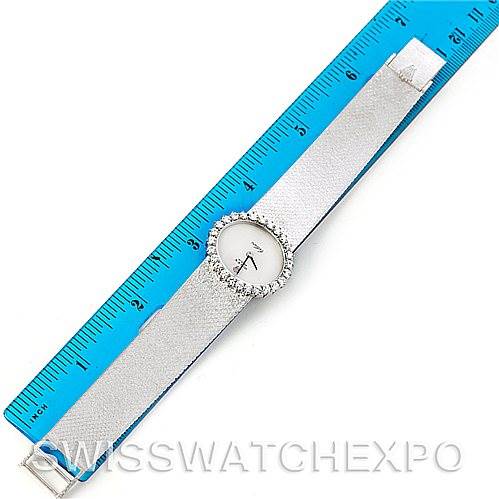 The image shows a top view of a Rolex Cellini Women's Yellow Gold Silver Dial Women's Yellow Gold Silver Dial watch laid next to a blue measuring tape.