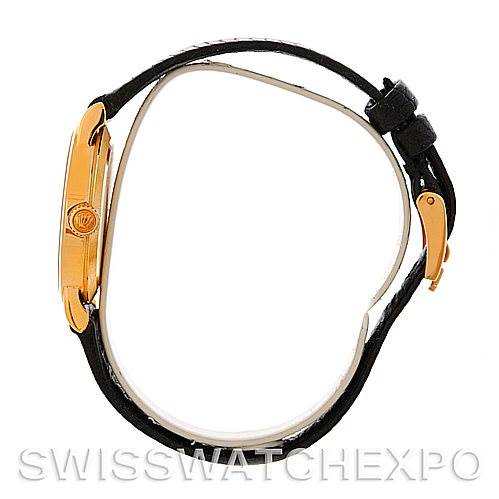 This image shows the Rolex Cellini 5109 Women's Yellow Gold White Dial 5109 Women's Yellow Gold White Dial watch from a side angle, highlighting its gold case and black leather strap.