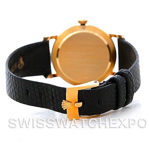 The image shows the back view of a Rolex Cellini 5109 Women's Yellow Gold White Dial 5109 Women's Yellow Gold White Dial watch, highlighting its gold case and black leather strap with a gold buckle.