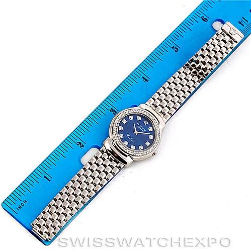 The Rolex Cellini 6671/9 Women's White Gold Blue Dial 6671/9 Women's White Gold Blue Dial watch is shown in a top-down view, displaying its face, bracelet, and a partial ruler for size reference.