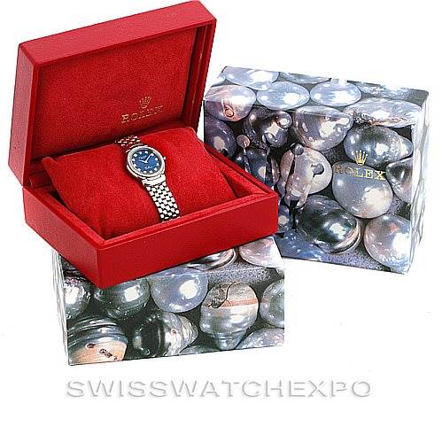 The image shows a Rolex Cellini 6671/9 Women's White Gold Blue Dial 6671/9 Women's White Gold Blue Dial watch positioned in its open red case, placed on matching decorative boxes.