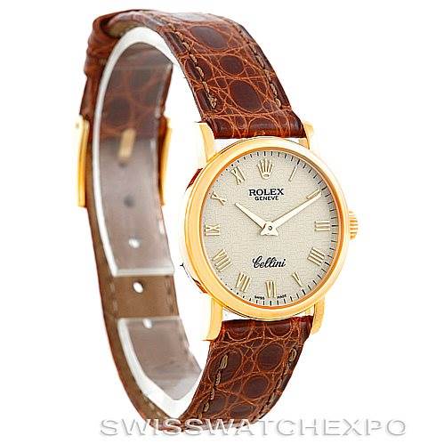 The image shows a Rolex Cellini 6110 Women's Yellow Gold Beige Dial 6110 Women's Yellow Gold Beige Dial watch from a side angle, displaying its gold bezel, brown leather strap, and dial with Roman numerals.