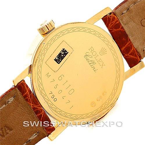 This image shows the back side of the Rolex Cellini 6110 Women's Yellow Gold Beige Dial 6110 Women's Yellow Gold Beige Dial watch, highlighting its case back details and leather strap.