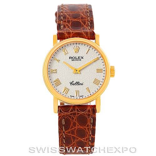 The Rolex Cellini 6110 Women's Yellow Gold Beige Dial 6110 Women's Yellow Gold Beige Dial watch is shown from a front angle, displaying its round dial, gold case, and brown leather strap.