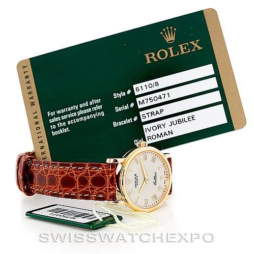 This image shows a Rolex Cellini 6110 Women's Yellow Gold Beige Dial 6110 Women's Yellow Gold Beige Dial watch with an ivory jubilee dial and brown leather strap, alongside its warranty card.