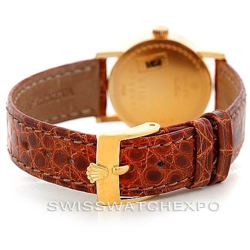 This image shows the back of a Rolex Cellini 6110 Women's Yellow Gold Beige Dial 6110 Women's Yellow Gold Beige Dial watch with a brown leather strap and a gold buckle.