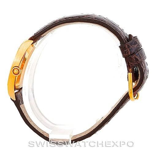 This image shows the side view of a Rolex Cellini 4129 Women's Yellow Gold White Dial 4129 Women's Yellow Gold White Dial watch, highlighting its gold crown and brown leather strap.