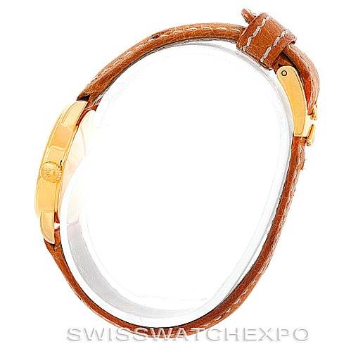 This image shows a side profile of the Rolex Cellini 6110 Women's Yellow Gold Silver Dial 6110 Women's Yellow Gold Silver Dial model with a golden case and brown leather strap.