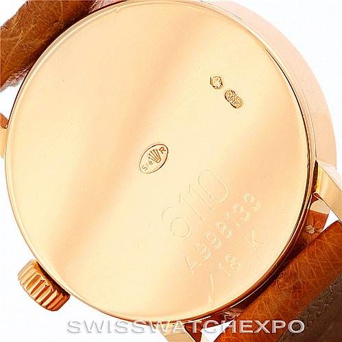 This image shows the back case and crown of a Rolex Cellini 6110 Women's Yellow Gold Silver Dial 6110 Women's Yellow Gold Silver Dial model watch, highlighting its engravings and markings.