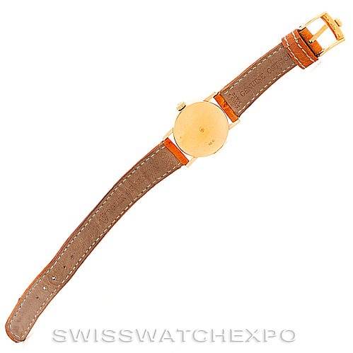 This is a top view of a Rolex Cellini 6110 Women's Yellow Gold Silver Dial 6110 Women's Yellow Gold Silver Dial watch, showing the watch's back, gold case, and brown leather strap.