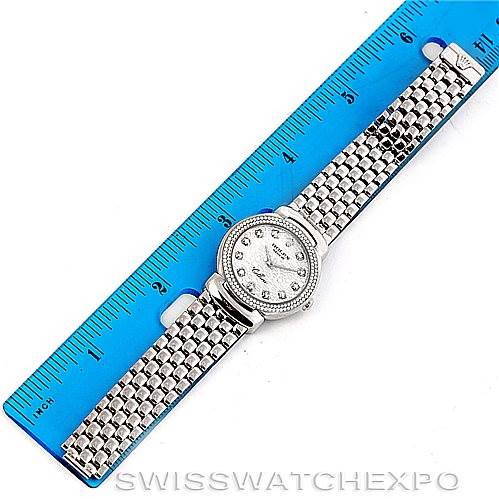 The image shows a top view of a Rolex Cellini 6671/9 Women
s White Gold Silver Dial 6671/9 Women
s White Gold Silver Dial watch, placed next to a blue ruler for size reference.