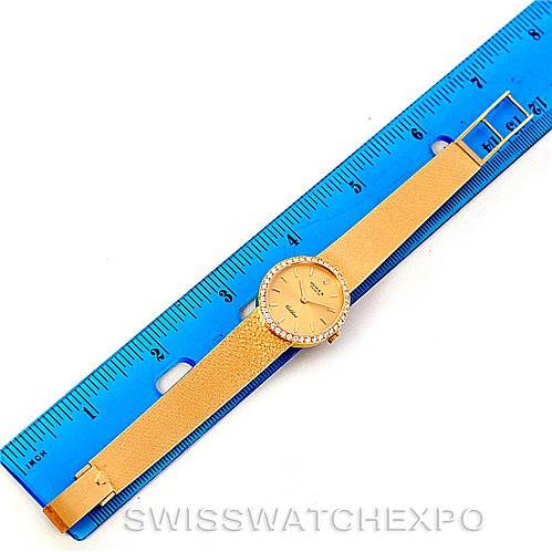 The Rolex Cellini 4625 Women's Yellow Gold Champagne Dial 4625 Women's Yellow Gold Champagne Dial watch is shown flat, with the face, bezel, and entire strap visible next to a blue ruler for scale.