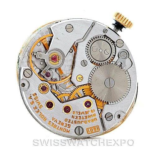 The image shows the internal mechanical movement of a Rolex Cellini 4625 Women's Yellow Gold Champagne Dial 4625 Women's Yellow Gold Champagne Dial watch, highlighting gears, jewels, and the winding crown.