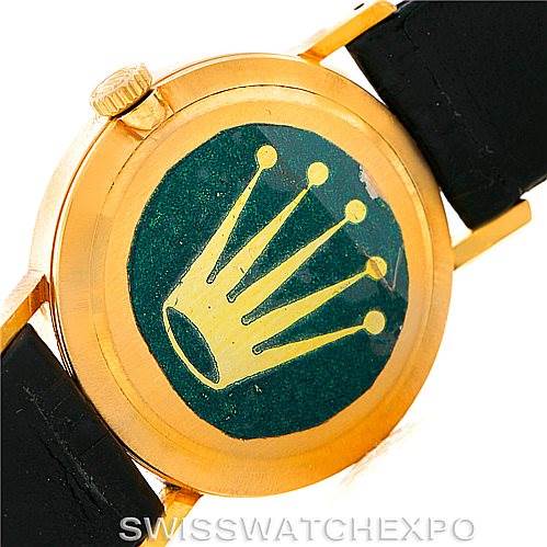 The image shows the case back of a Rolex Cellini 4306 Women's Yellow Gold Grey Dial 4306 Women's Yellow Gold Grey Dial watch at an oblique angle, highlighting its crown logo sticker and strap attachment.