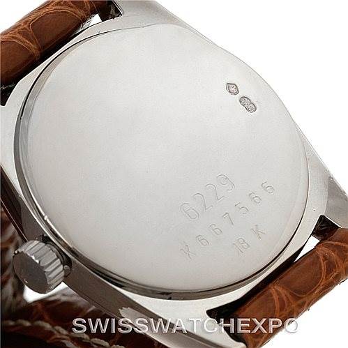 The image shows the back case of a Rolex Cellini 6229 Women's White Gold Black Dial 6229 Women's White Gold Black Dial watch from an angle focusing on the engravings and brown leather strap.