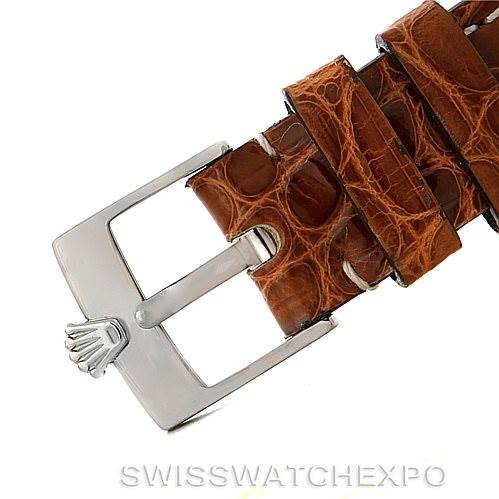 The image shows a close-up view of the buckle and part of the brown leather strap of a Rolex Cellini 6229 Women's White Gold Black Dial 6229 Women's White Gold Black Dial watch.