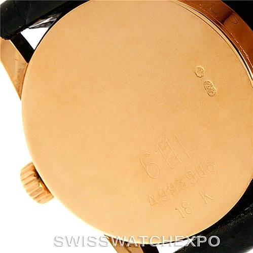 This image shows the back case and crown of a Rolex Cellini 6111 Women's Yellow Gold Black Dial 6111 Women's Yellow Gold Black Dial watch, highlighting its 18K gold material and engraved details.